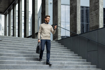 Young professional walking down urban steps, looking at smartphone with confident expression,...