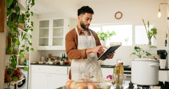 Food, recipe and tablet with man in kitchen of home for cooking ingredients or instructions on internet. Apron, counting and preparation with chef person in apartment for diet, health or nutrition