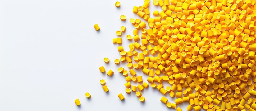 Yellow masterbatch granules displayed on a white background for an industrial plastic product catalog with copy space image