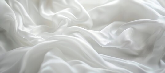 Obraz premium Elegant white silk or satin luxury fabric background with wave folds. Soft and delicate texture.