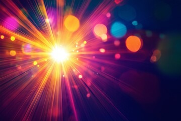 Bright explosion of colorful light rays with bokeh effect creating a vibrant atmosphere at night