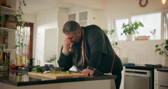 Chef, pain and man in kitchen, headache and thinking with burnout in restaurant, overworked and tired. Business, exhausted and stress of long hours, person and cook with migraine, sad and employee