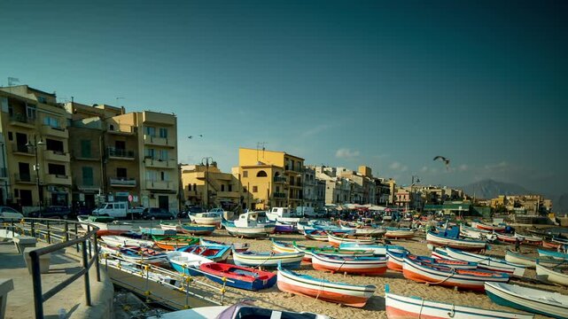 fishing boats and fishermen on the beach in the town of Aspra, sicily