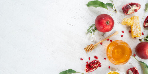 rosh hashana holiday - honey with apple and pomergranate over white desk background with copy space