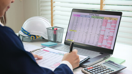 Expert woman asian female people review data number costing managerial account prepare monthly actual cost variance report at tax audit office. ESG sheet budget control ERP process service project.
