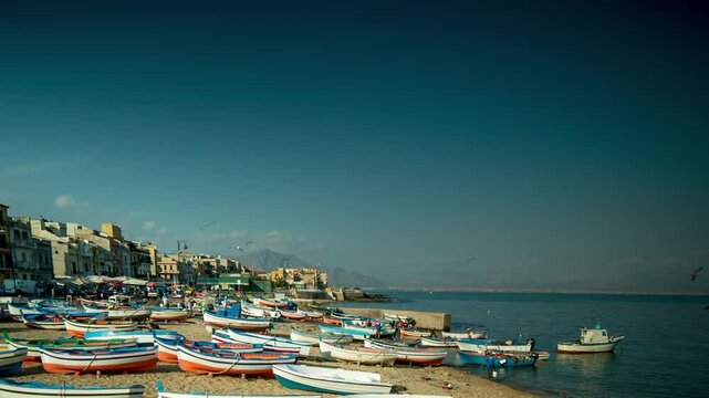 fishing boats and fishermen on the beach in the town of Aspra, sicily