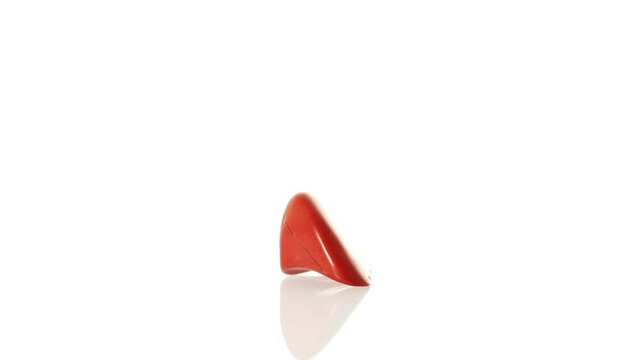 mineral stone red jasper rotates in a circle on a white background