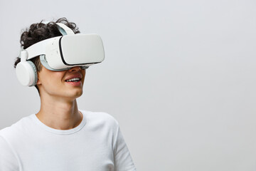 Virtual reality experience, young man smiling, wearing VR headset and headphones, modern technology...