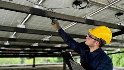 Technical engineer Inspecting the installation of the solar panels and checking the integrity of...