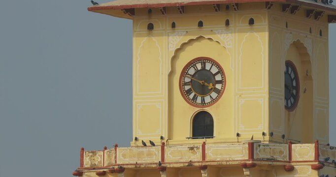 Jaipur, Rajasthan, India. Jantar Mantar Is Astronomical Observation Site Built In Early 18th Century. It Includes Set Of Some 20 Main Fixed Instruments. Tower Clock. Pigeons Sit On Tower Clock. Worlds