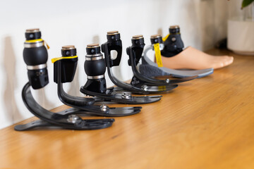 Prosthetic legs lined up on table in laboratory for medical use