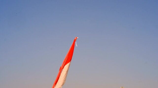 Footage of the Red and White Flag flying in a tilted position. The flag was installed to Celebrate the 79th Anniversary of the Independence Day of the Republic of Indonesia.. 4K Resolution 30 Fps