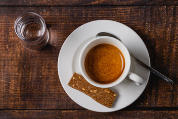 Espresso in white porcelain cup on wooden table. Espresso coffee