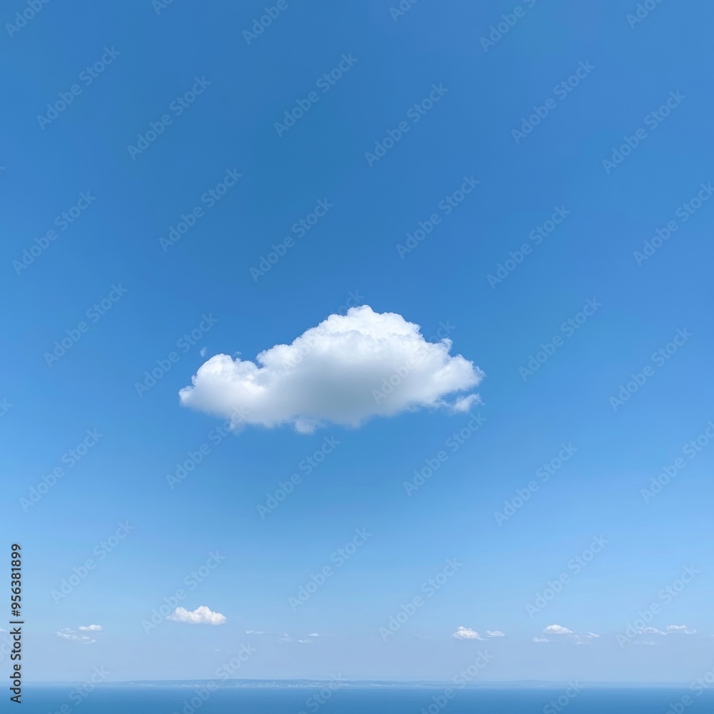 Poster A single, puffy white cloud drifts across a vast blue sky over a calm, blue ocean.