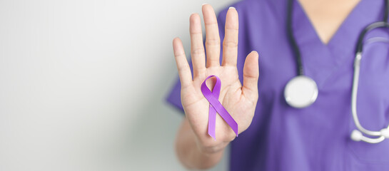 Doctor holding purple Ribbon for Violence, Pancreatic, Esophageal, Testicular cancer, Alzheimer,...