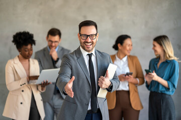 Portrait of successful group of business people at office. Multiethnic group of people smiling.