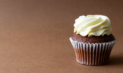 Chocolate cupcake on brown background. Dessert. Cooking. Baking. Vegetarian food.