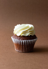 Chocolate cupcake on brown background. Dessert. Cooking. Baking. Vegetarian food.