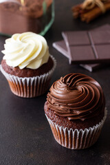 Chocolate cupcakes on brown background. Dessert. Cooking. Baking. Vegetarian food.