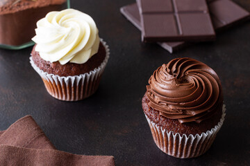Chocolate cupcakes on brown background. Dessert. Cooking. Baking. Vegetarian food.