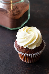 Chocolate cupcake on brown background. Dessert. Cooking. Baking. Vegetarian food.