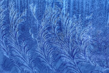 Abstract patterns on the window from frost. Winter nature background.