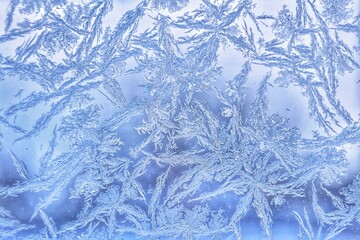 Abstract patterns on the window from frost. Winter nature background.