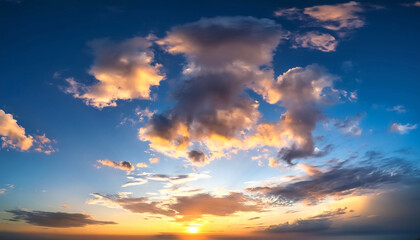 Fototapeta premium Sunset sky with a few clouds. The sky is very bright and the clouds are scattered throughout