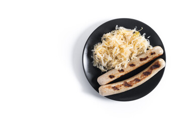 Bratwurst sausage and sauerkraut isolated on white background. Typical german food. Oktoberfest. Top view. Copy space