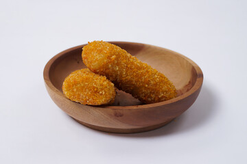 American Risoles or risoles mayo is a traditional Indonesian snack filled with smoked beef or sausage, boiled eggs & mayonnaise. Crispy texture on the outside. Risoles on wood plate isolated white.