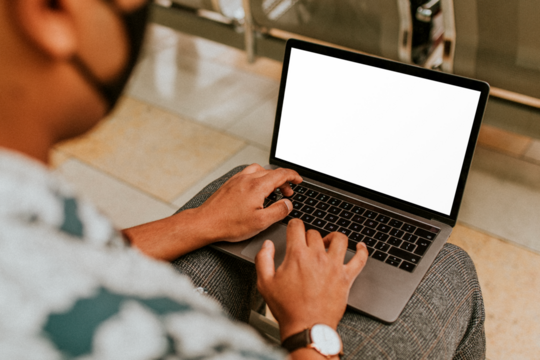 PNG Laptop screen mockup being used a mask wearing man in the new normal - Powered by Adobe
