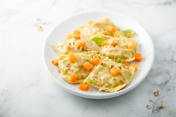 Homemade pumpkin ravioli with herbs and cheese
