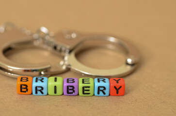 The image symbolizes the corrupt nature of bribery and the potential for arrest and imprisonment.