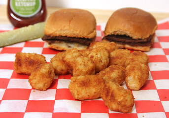 Tater Tots With Mini Hamburgers and Ketchup on Table