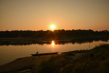Beautiful Sunset view over the river. A boatman is during the sunset. 