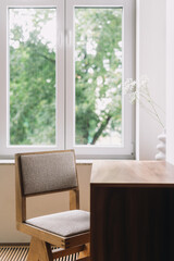 A minimalist workspace featuring a wooden desk and a comfortable chair