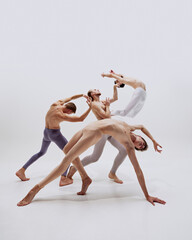 Capturing elegance of motion, dancers defy gravity, their bodies arching and curving in exquisite expression of contemporary dance. Concept of music and dance, modern and classical art, movement.