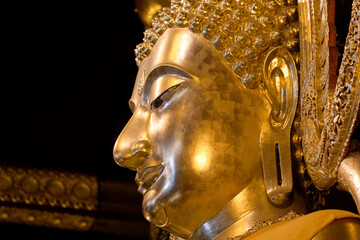 The golden Buddha head has traces of metal plate attachment.