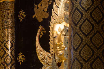The golden Buddha head has traces of metal plate attachment.