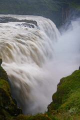 Powerful flow of Gullfoss waterfall with misty surroundings