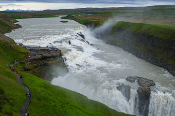 Tourists exploring Gullfoss waterfall in Iceland
