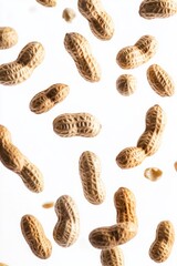 A group of peanuts falling against a white background.