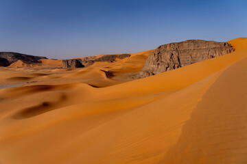 Sahara desert, sand, dunes and rocks in Algeria. Surrounding of Djanet. Place of Sahara named Moul...