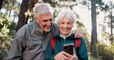 Phone, hiking or senior couple laughing in nature for connection, social media or streaming in forest. Norway, smile or happy people trekking in woods for funny meme comedy, travel and mobile app - Powered by Adobe