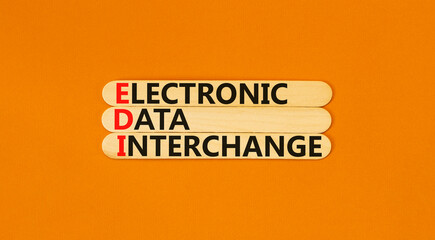 EDI electronic data interchange symbol. Concept words EDI electronic data interchange on wooden stick. Beautiful orange background. Business and EDI electronic data interchange concept. Copy space.