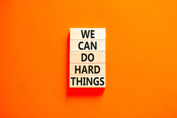 We can do hard things symbol. Concept words We can do hard things on wooden blocks. Beautiful orange table orange background. Business, we can do hard things concept. Copy space.