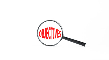 Objectives symbol. Concept word Objectives in beautiful magnifying glass. Beautiful white paper background. Business objectives concept. Copy space.