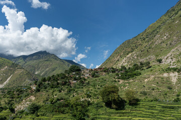 Traditional mountain village in Nepal. Mountain village landscape with monsoon clouds.