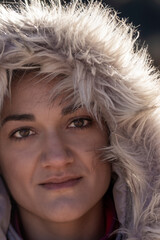 Close-up Portrait of a Woman in Winter Fur Hood with a Warm, Intense Gaze