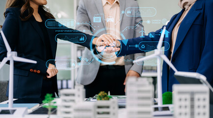 Group of diverse multiethnic businesspeople standing neare table looking at model of building from residential project.